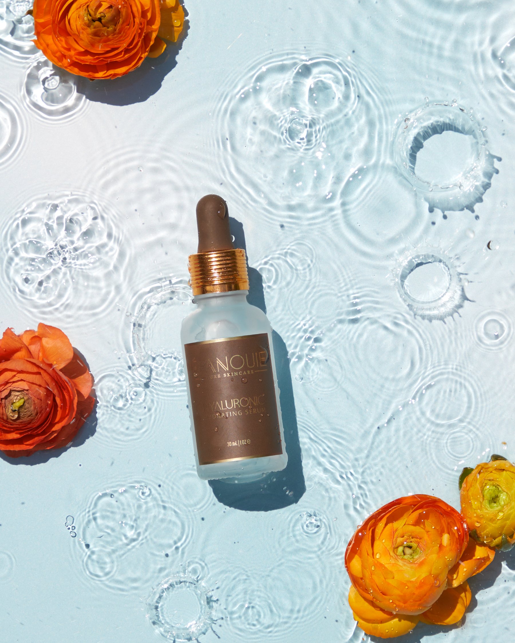 Hyaluronic Hydrating Serum on water with ranunculus