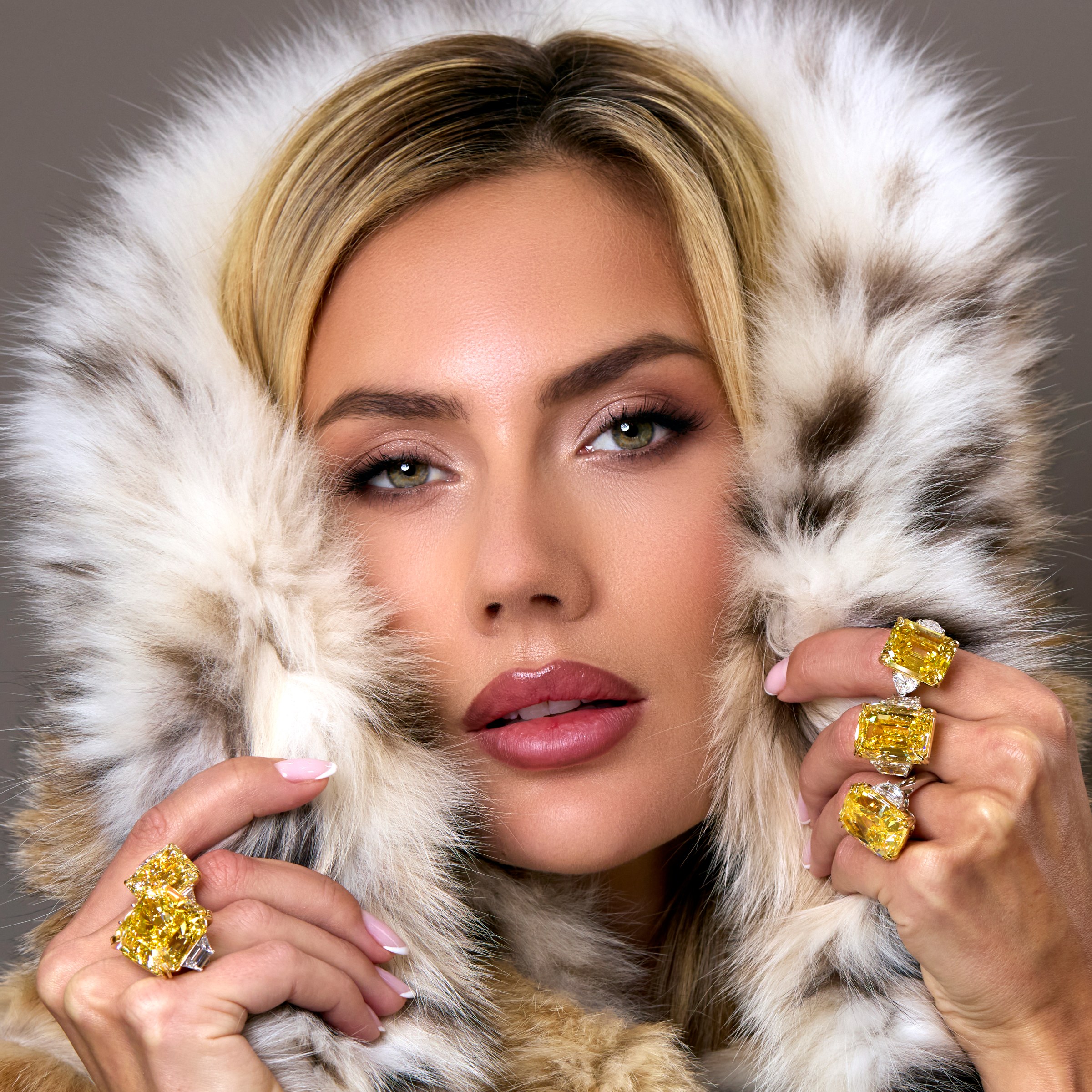 Yellow diamond rings on model in fur hood