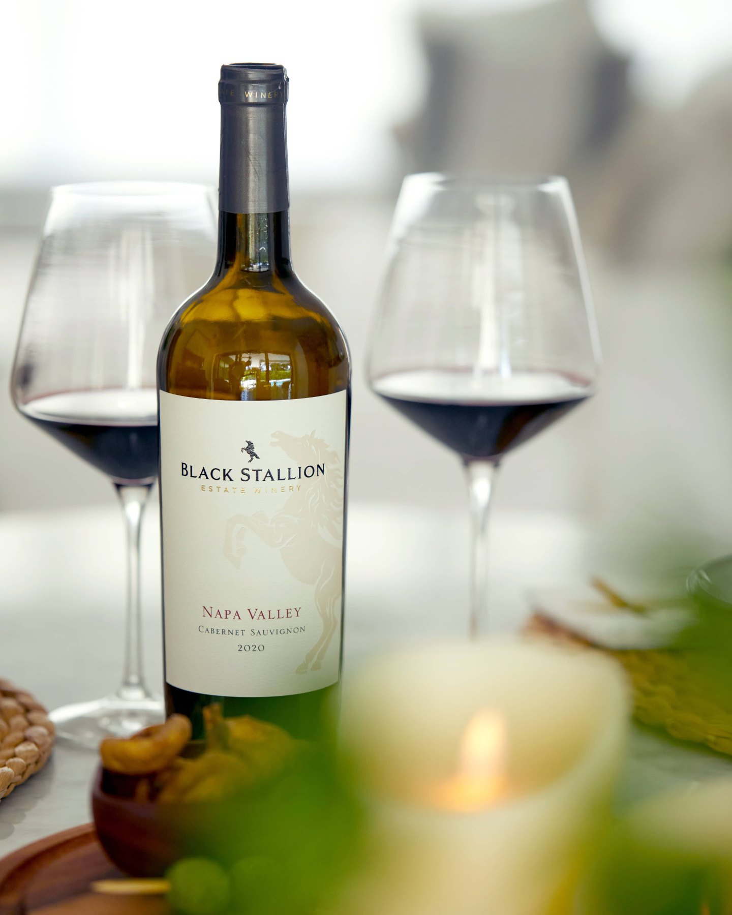Black Stallion wine with glasses at an evening table